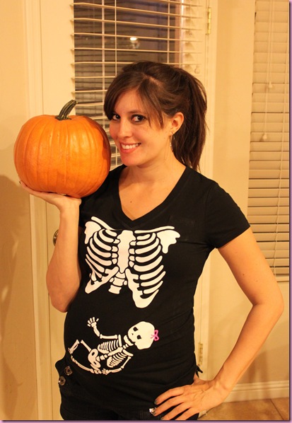In a skeleton shirt with a pumpkin