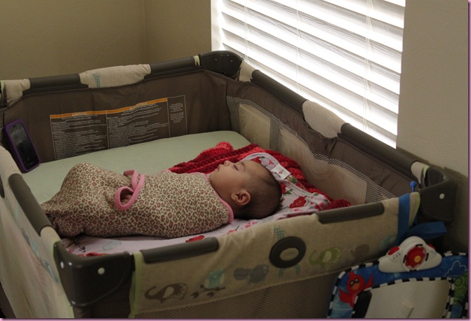 baby sleeping in pack and play bassinet