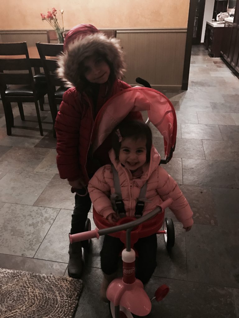 P in her trike, Livi in her furry coat