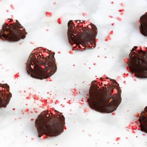 Crispy chocolate strawberry truffles! A delicious and lower-sugar dessert option; perfect for Valentine's Day (or any day). These are super easy to make, gluten-free and easy to make vegan. fitnessista.com