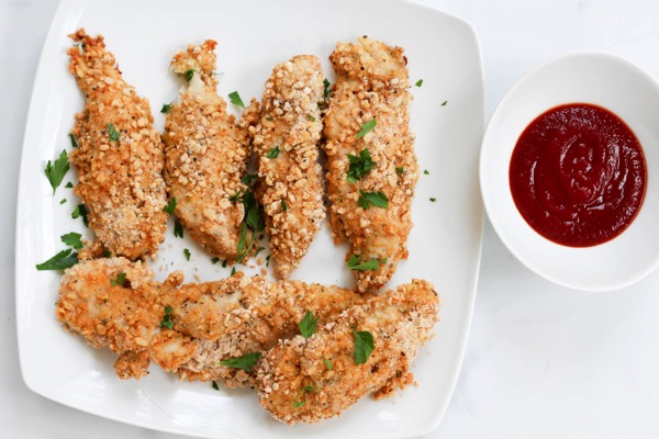 Gluten free dairy free healthy baked chicken tenders. A quick and easy dinner or lunch recipe! fitnessista.com