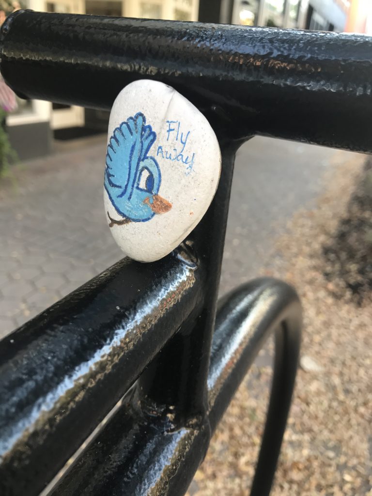 painted blue birdie on a white rock