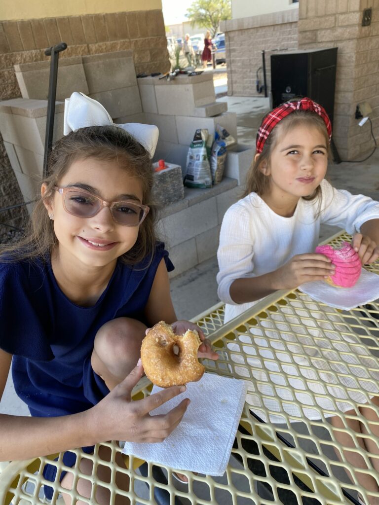 sisters eating donut